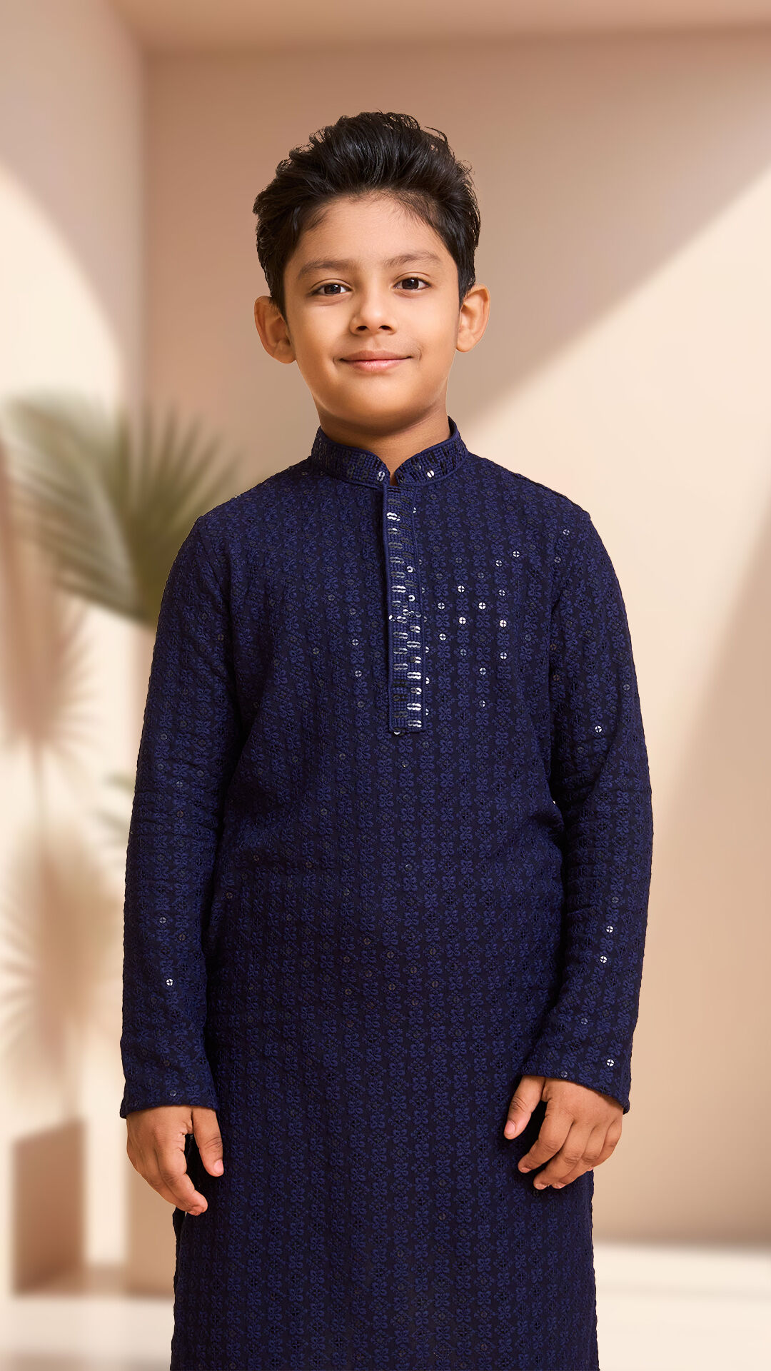 Boy wearing a dark blue chikankari kurta and pajama for function